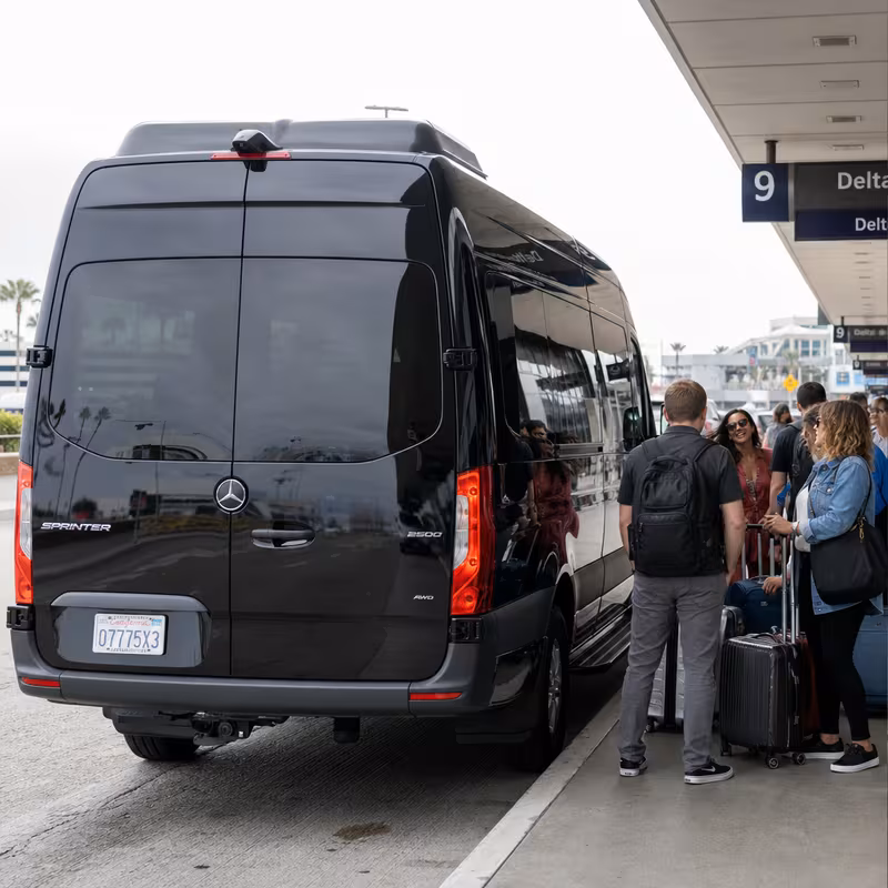 Group boarding a white charter bus for Airport Transportation transportation in Memphis