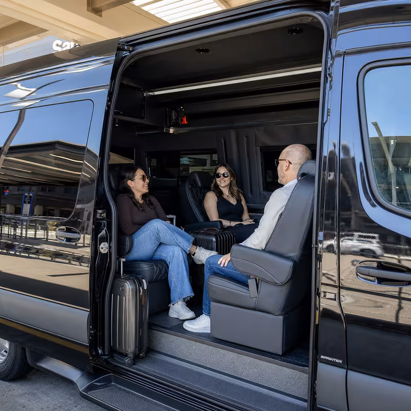 Passengers loading luggage while boarding an Memphis group shuttle