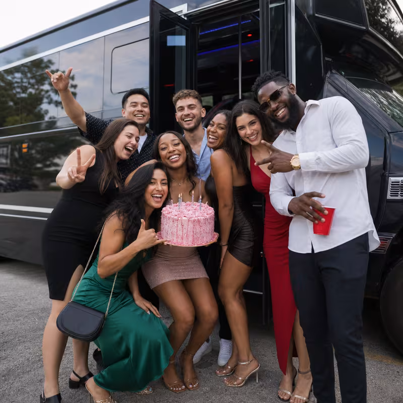 Group boarding a white charter bus for Birthday Transportation transportation in Memphis