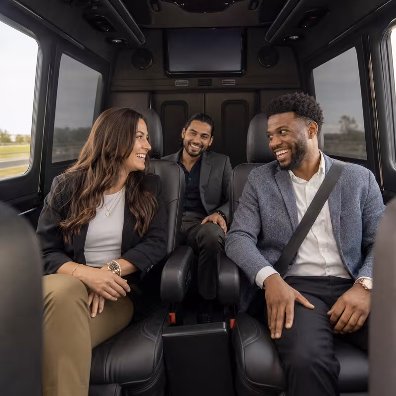 Group boarding a white charter bus for Corporate Transportation transportation in Memphis