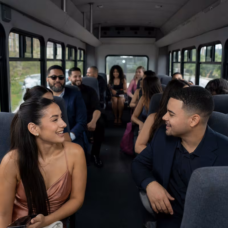 Group boarding a white charter bus for Private Event Transportation transportation in Memphis
