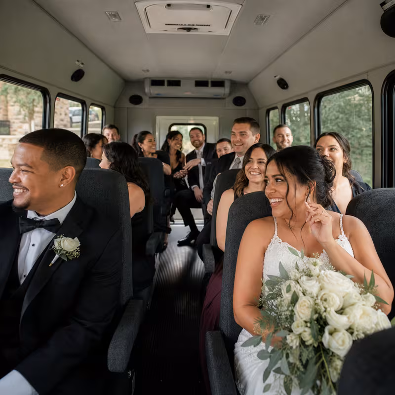 Group boarding a white charter bus for Wedding Transportation transportation in Memphis